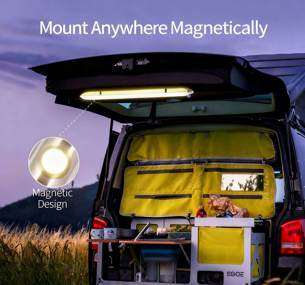 Van with magnetic light attached, set against a mountainous landscape.
