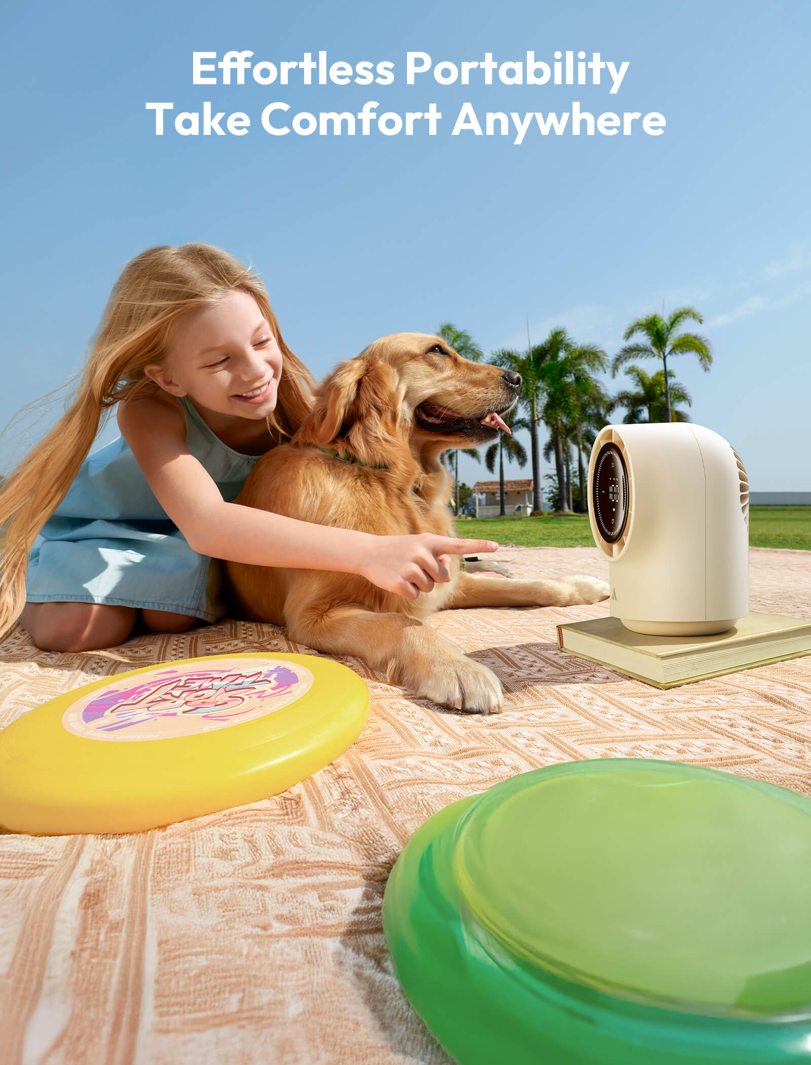 Girl with dog and portable device on blanket outdoors