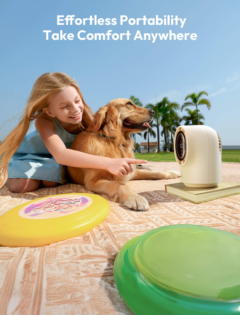 Girl with dog and portable device on blanket outdoors