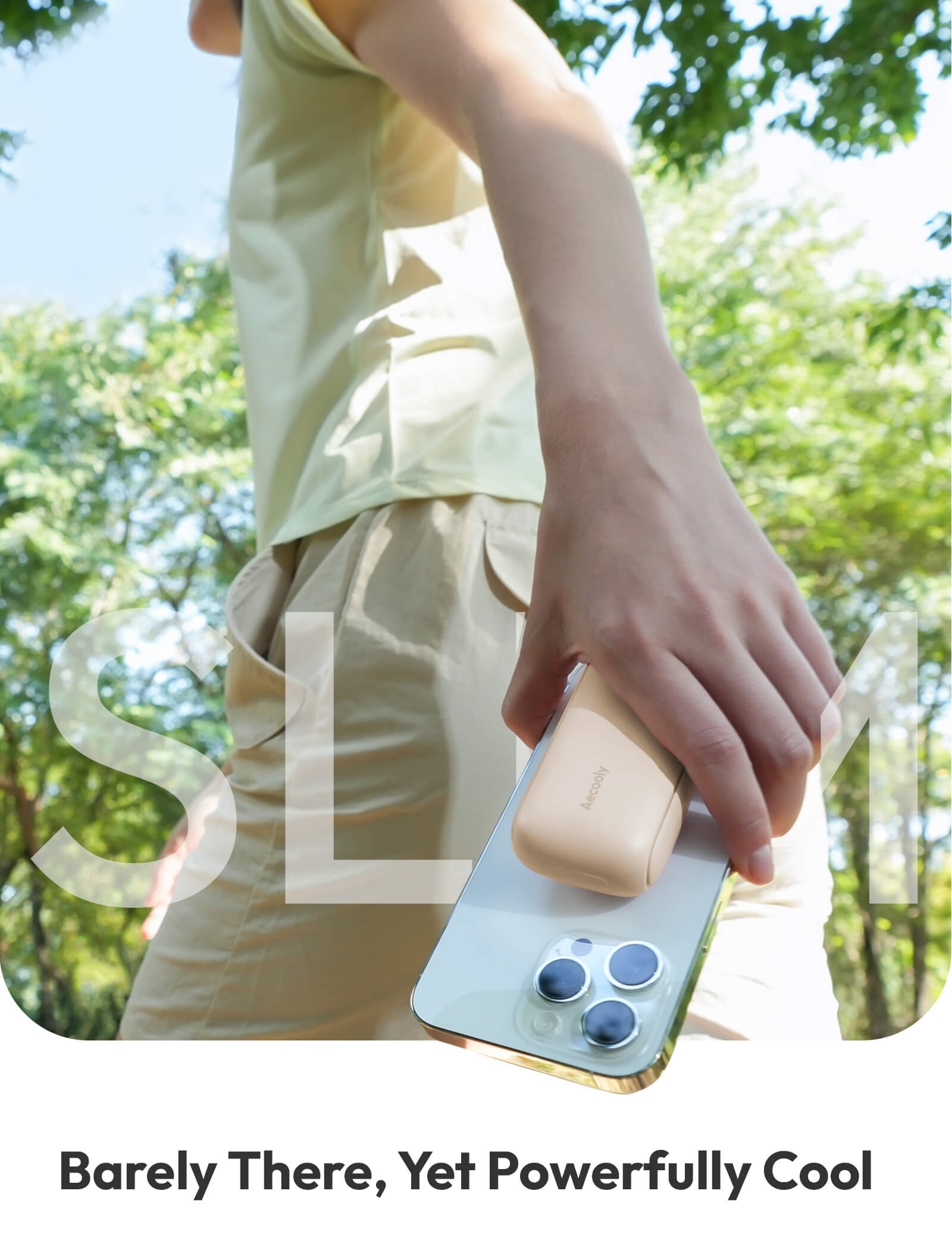 Person holding a phone with a clear case outdoors, surrounded by greenery.
