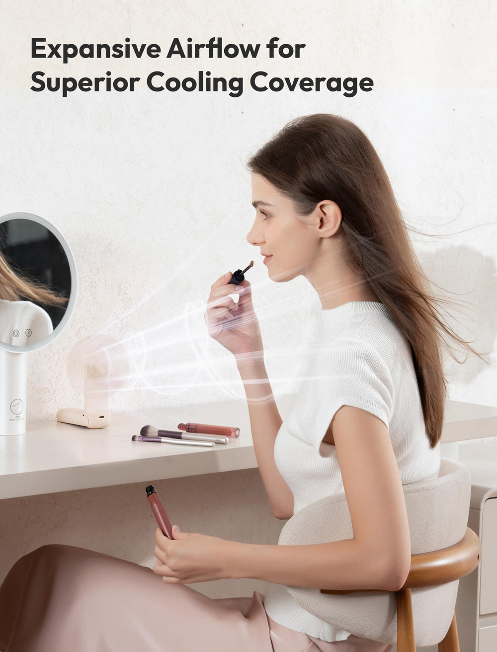 Woman applying makeup in a well-lit room with text about expansive airflow for cooling coverage.