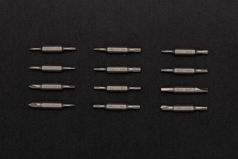 Set of screwdriver bits arranged in a grid on a black background