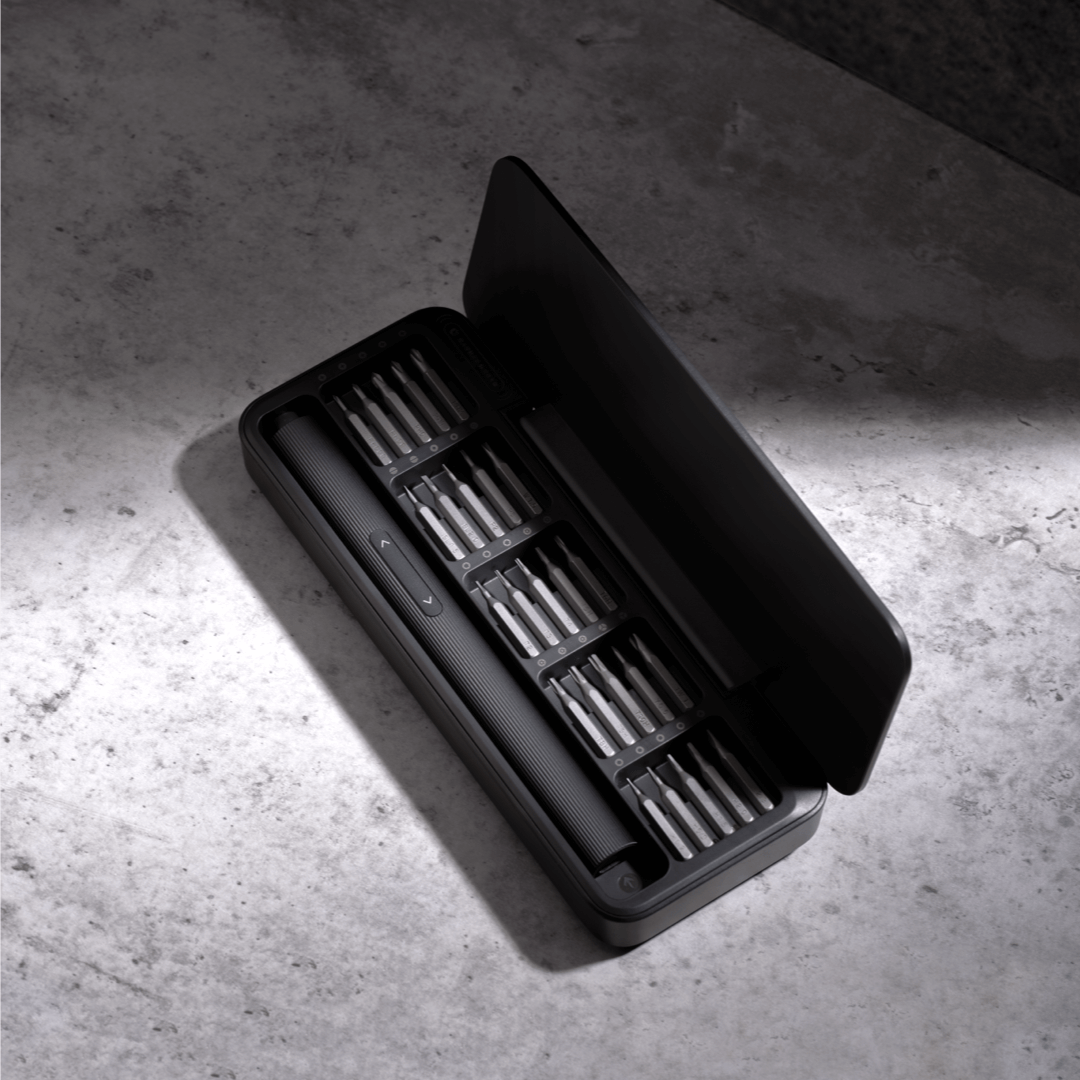Black tool case with compartments on a concrete surface
