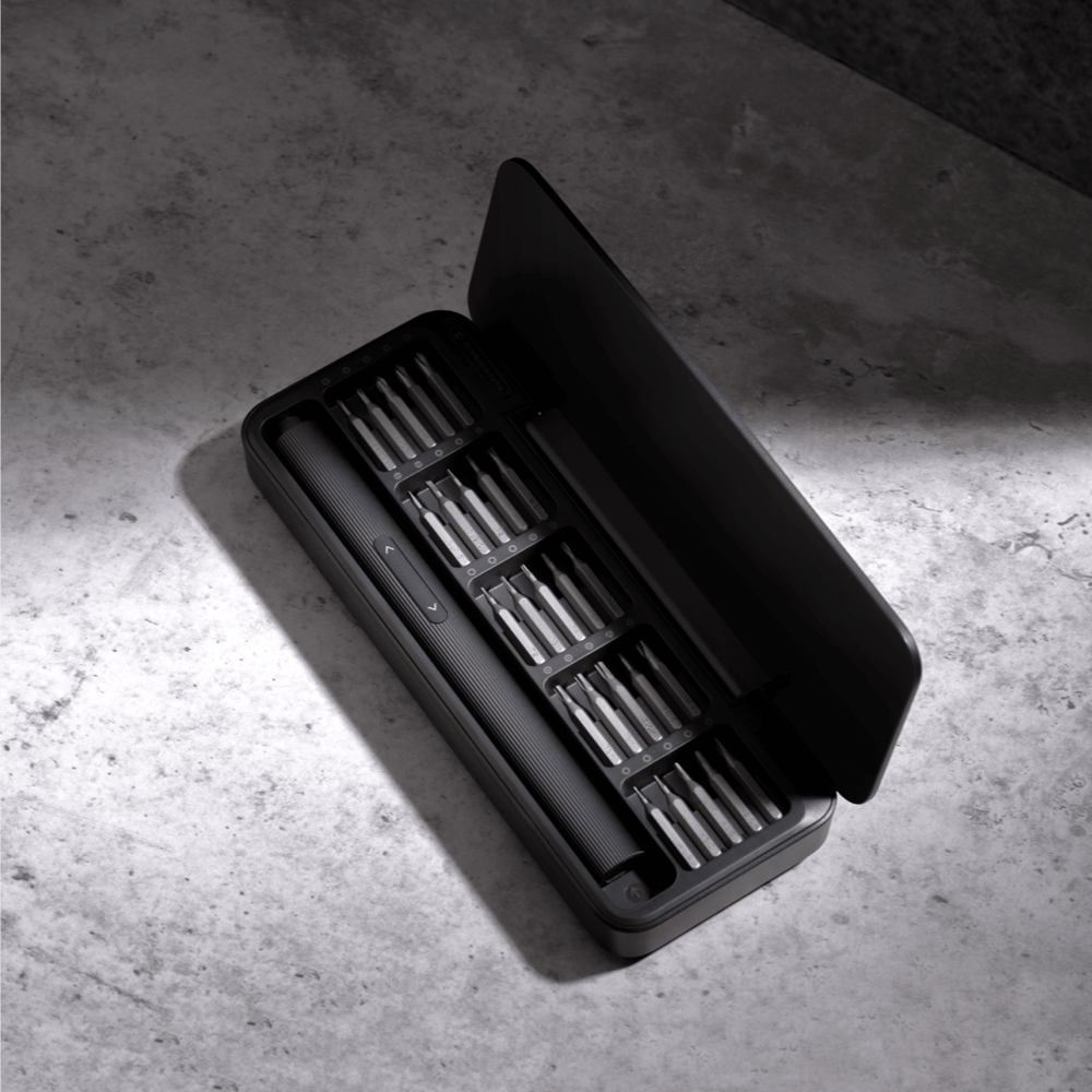 Black tool case with compartments on a concrete surface