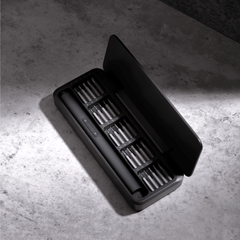 Black tool case with compartments on a concrete surface