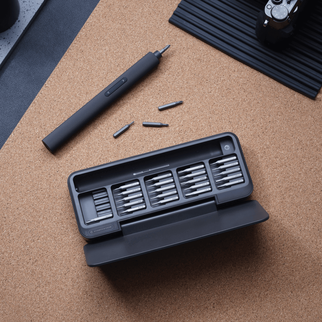 Black screwdriver set with bits on a cork surface