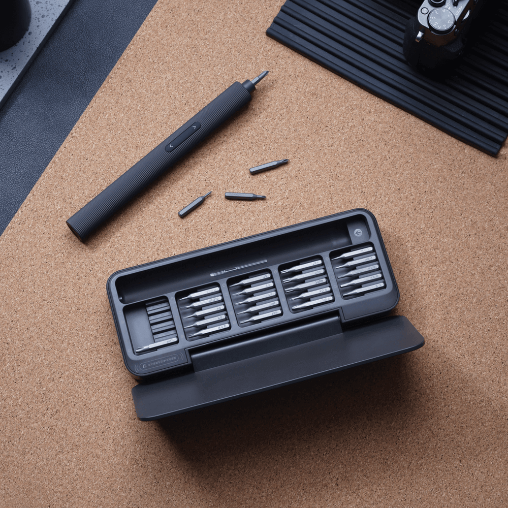 Black screwdriver set with bits on a cork surface