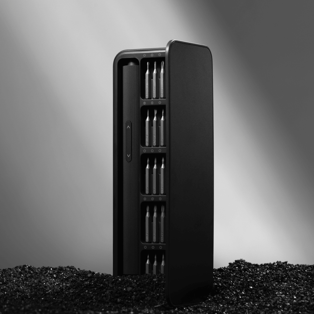 Black metal case with multiple compartments on a gray background