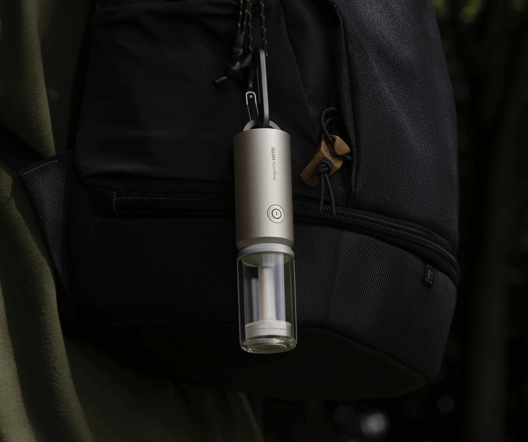 Portable wine opener attached to a black backpack