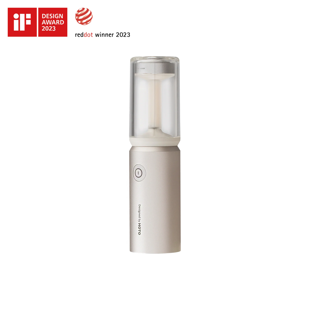 White handheld device with clear top section on a white background, featuring design awards.