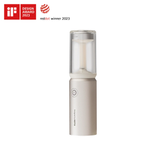 White handheld device with clear top section on a white background, featuring design awards.