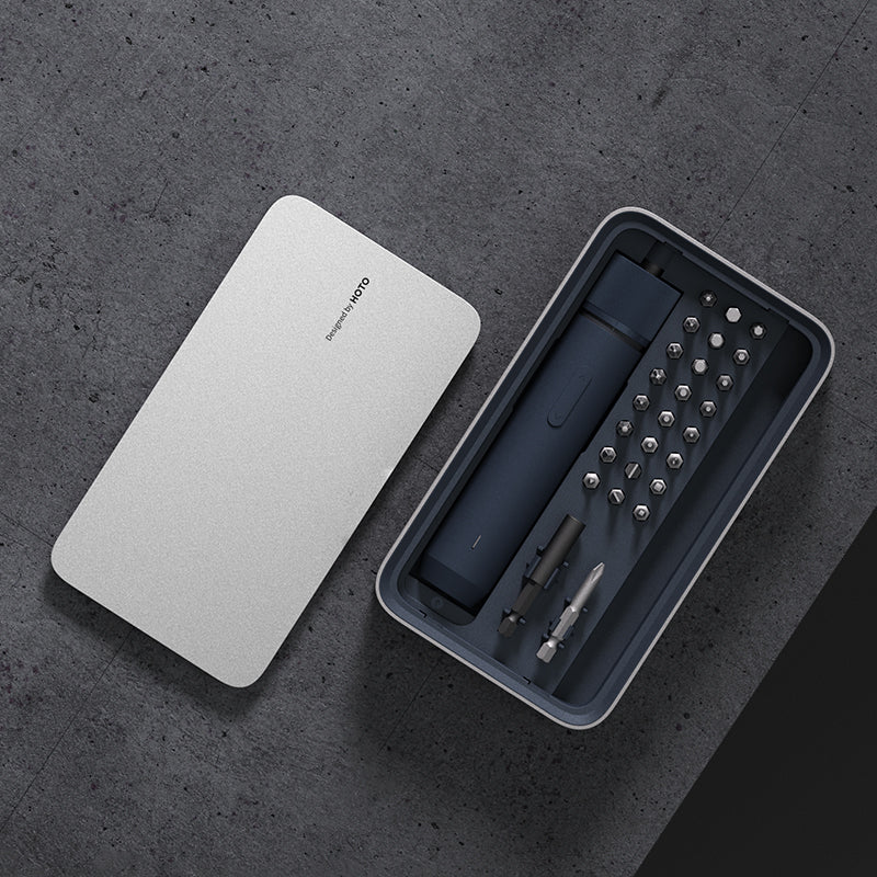 Set of tools in a black case with a white lid on a dark gray surface