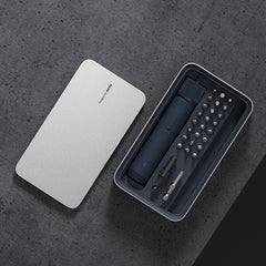 Set of tools in a black case with a white lid on a dark gray surface