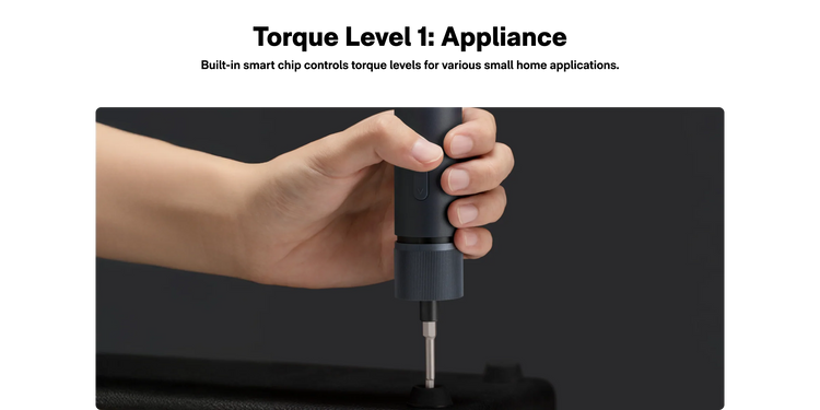 Hand holding a black appliance with text about torque level control on a dark background