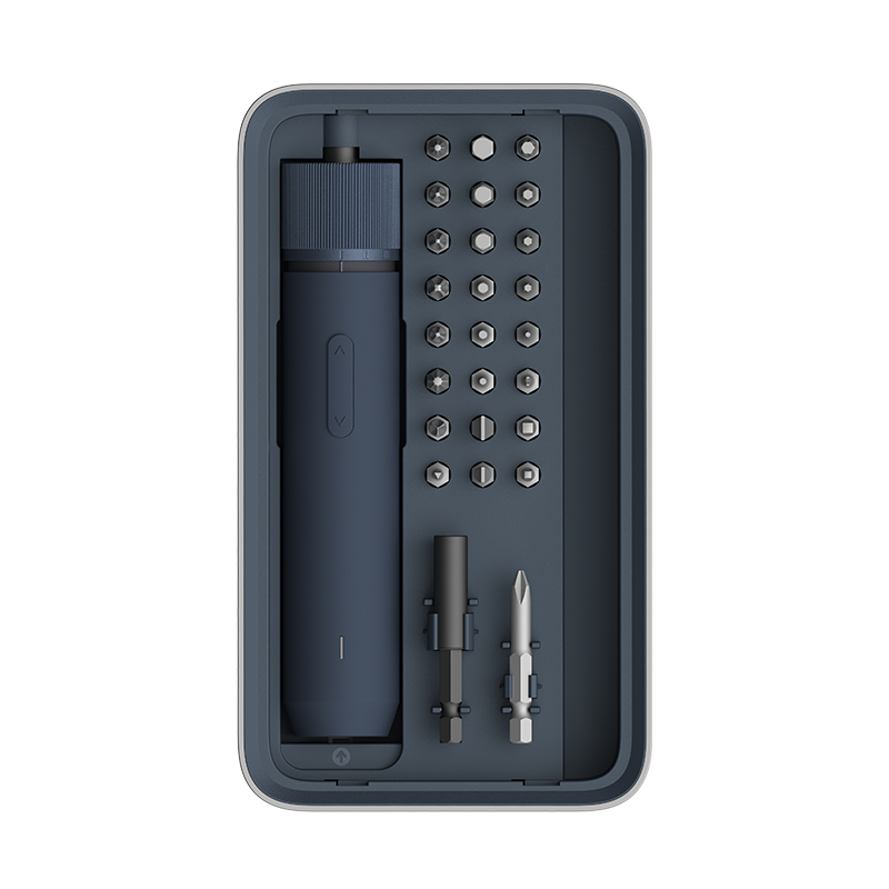 Set of tools including a drill and various bits in a black case on a white background