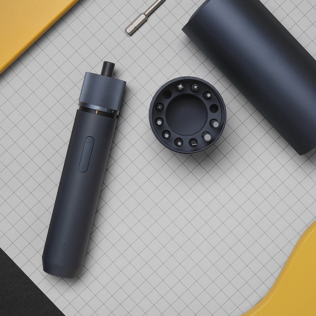 Black handheld device with a cylindrical component on a grid background