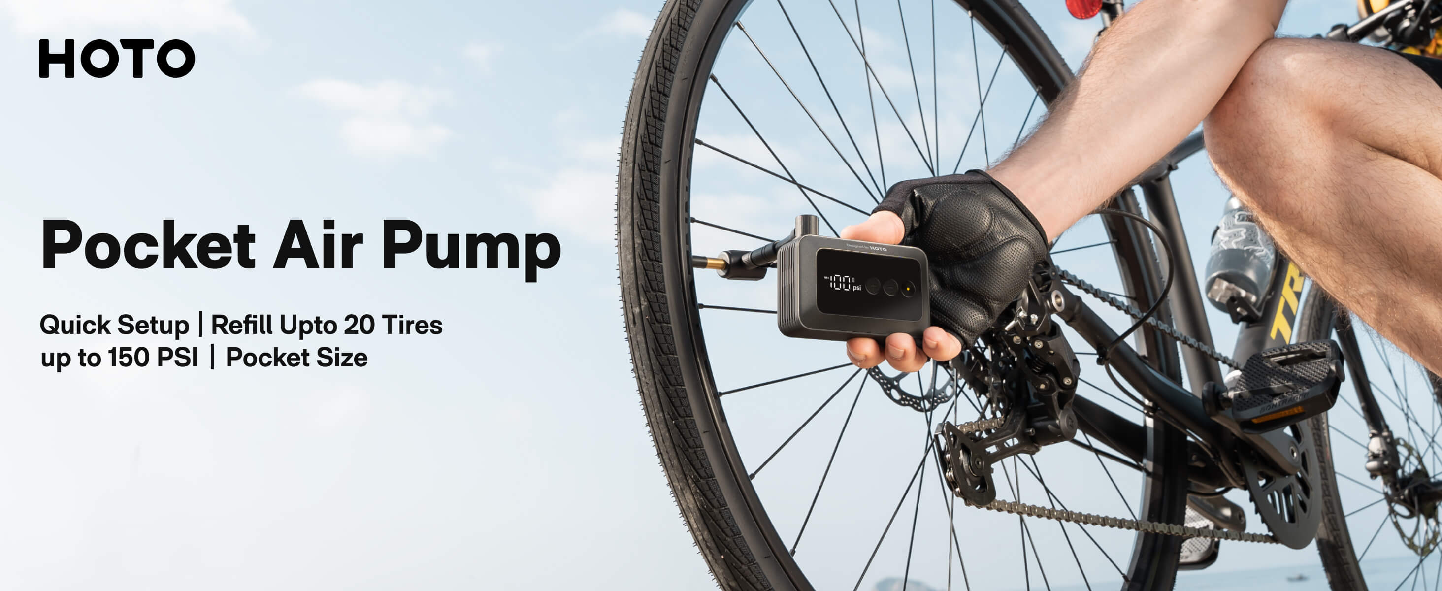 HOTO pocket air pump being used on a bicycle with a clear sky background