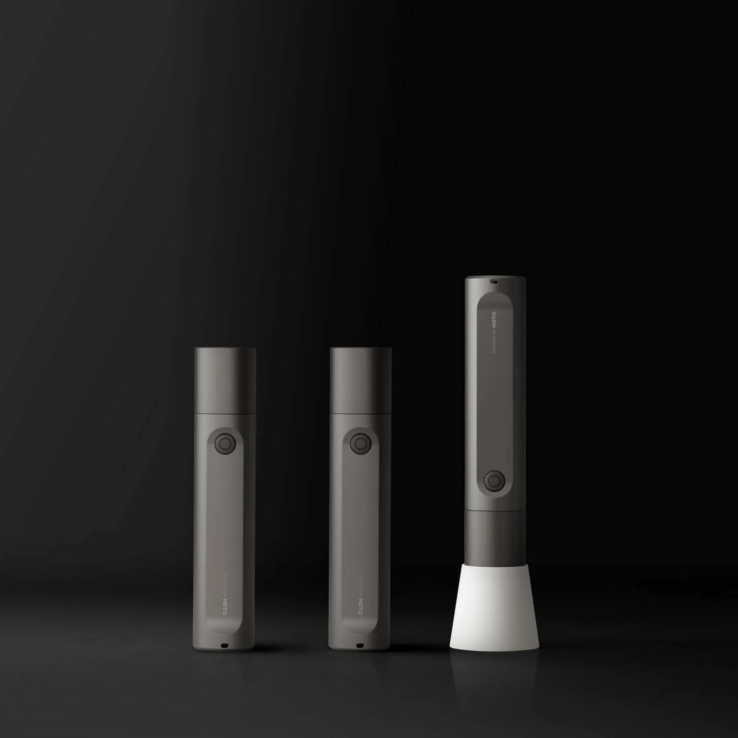 Three cylindrical electronic devices of varying sizes on a black background